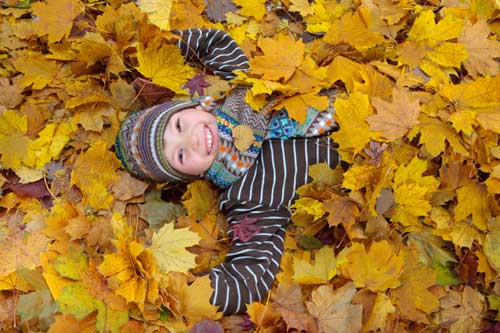 Child Playing in Leaves