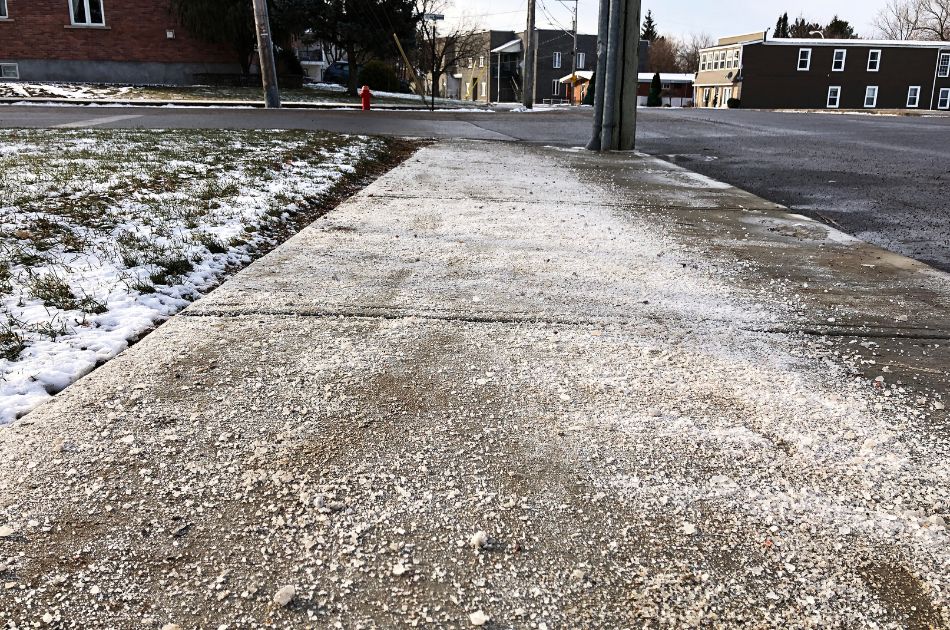 Salt or ice melt strewn over a New Jersey sidewalk.